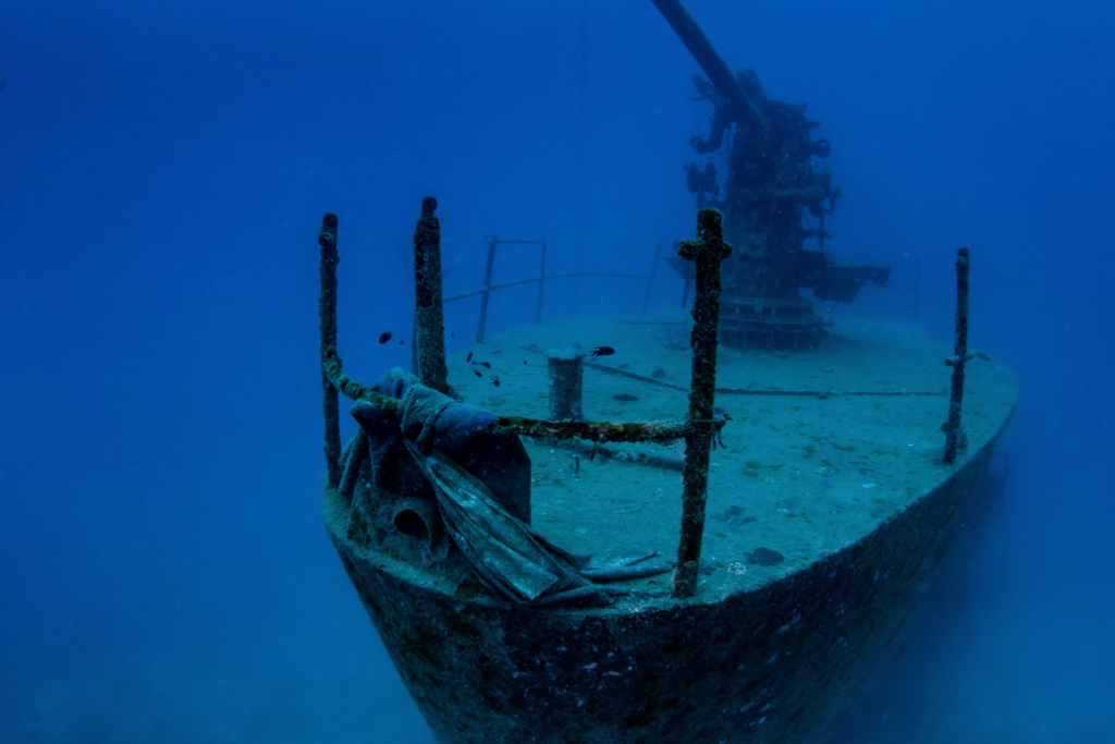 Underwater view of a sunken shipwreck near Koh Tao, perfect for scuba diving enthusiasts exploring marine history and vibrant aquatic life.
